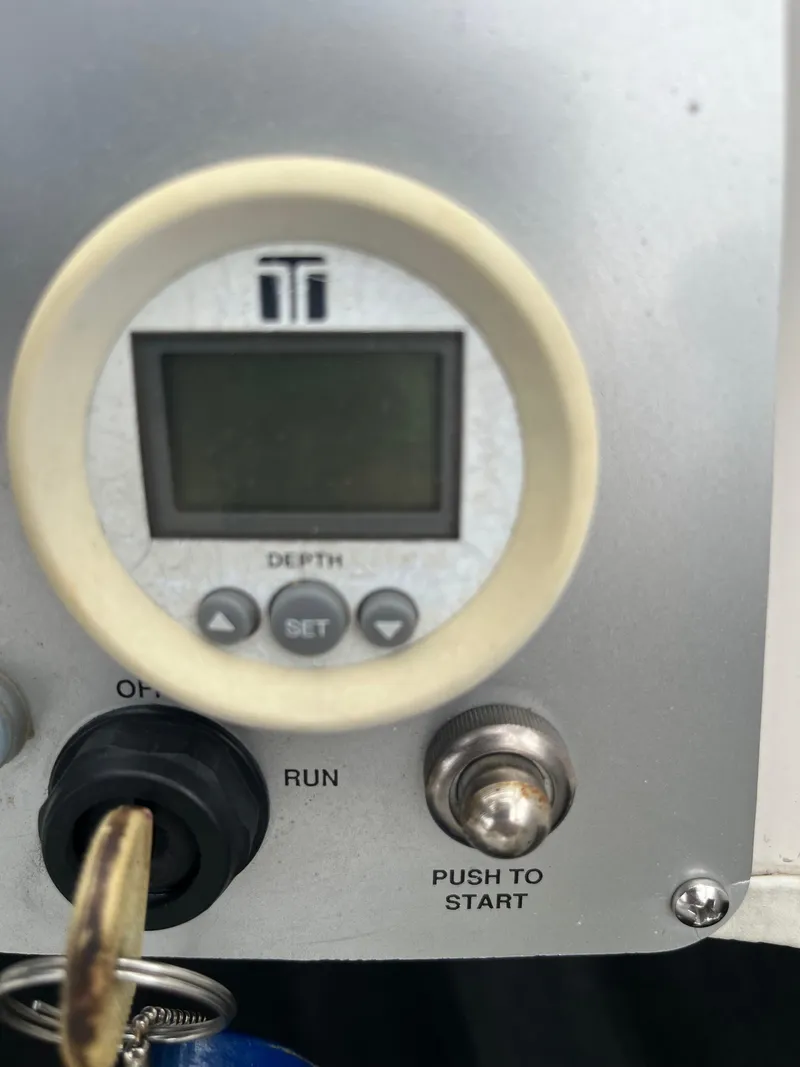 Slide: The Image of Control panel of a 2004 Tigé 20V Limited Edition boat with depth gauge and ignition switch. - 10