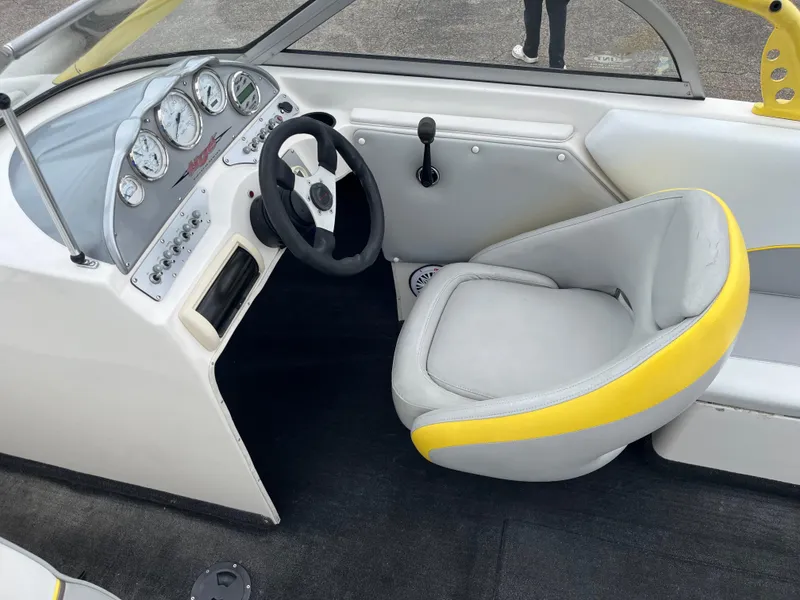 Slide: The Image of 2004 Tigé 20V Limited Edition boat interior with steering wheel and dashboard controls. - 12