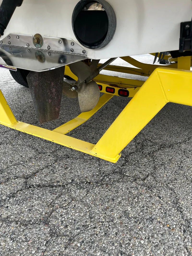 Slide: The Image of 2004 Tigé 20V Limited Edition boat propeller and yellow trailer on pavement. - 14