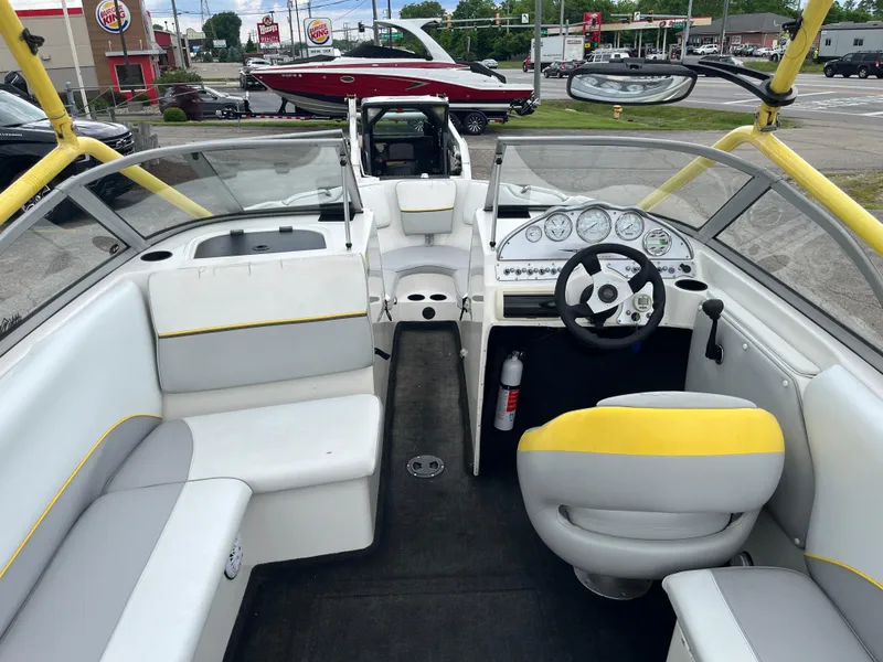 Slide: The Image of 2004 Tigé 20V Limited Edition boat interior with yellow accents and dashboard view. - 4