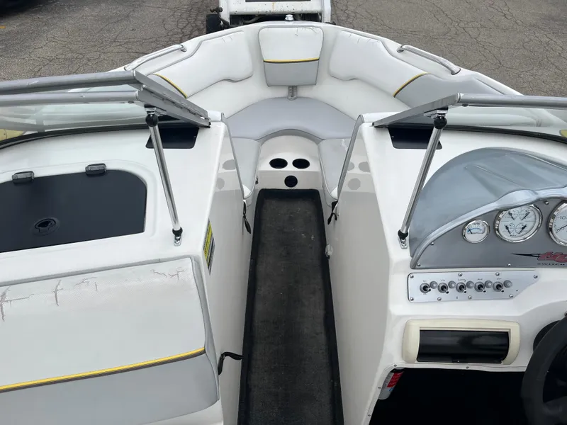 Slide: The Image of 2004 Tigé 20V Limited Edition boat interior with white seating and dashboard controls. - 7
