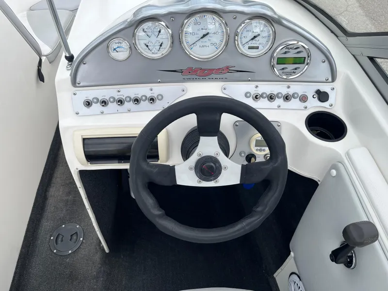Slide: The Image of 2004 Tigé 20V Limited Edition boat dashboard with steering wheel and gauges. - 9