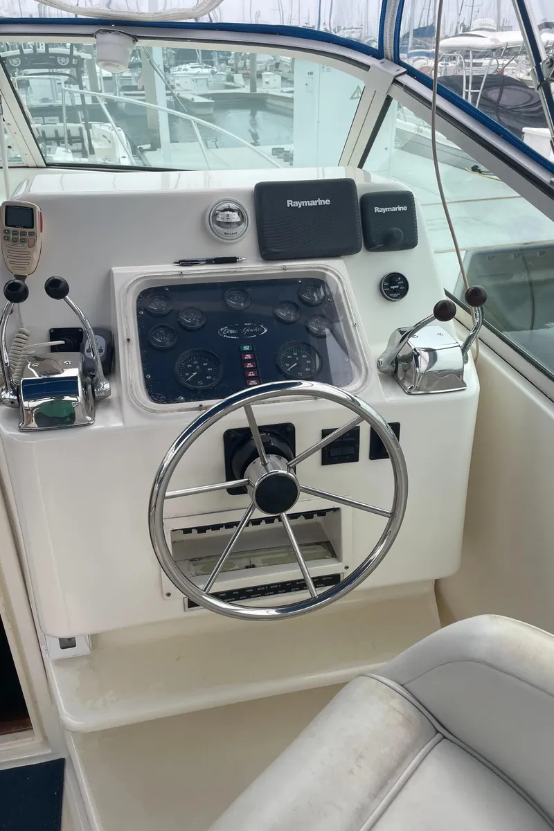 Slide: The Image of 1992 Ocean Yachts Sport Cruiser helm with steering wheel and navigation instruments. - 13