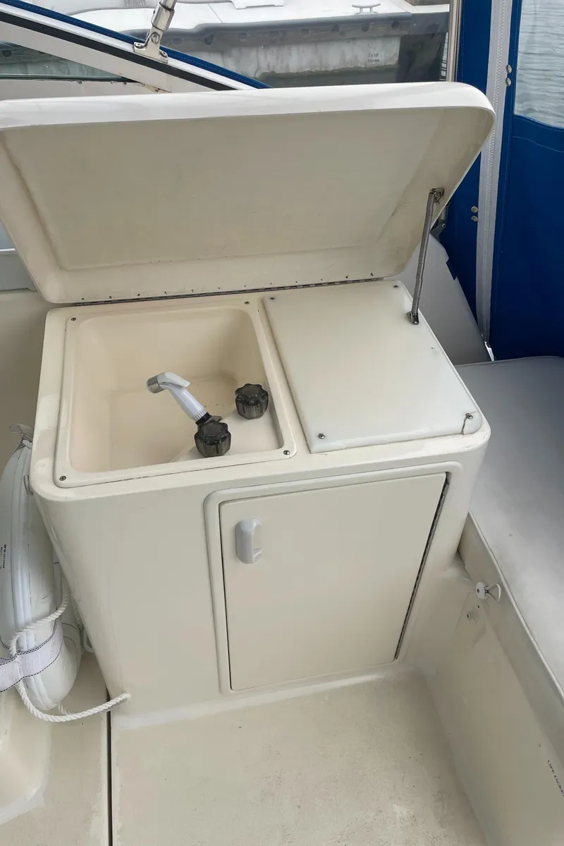 Slide: The Image of 1992 Ocean Yachts Sport Cruiser sink and storage area on deck. - 14
