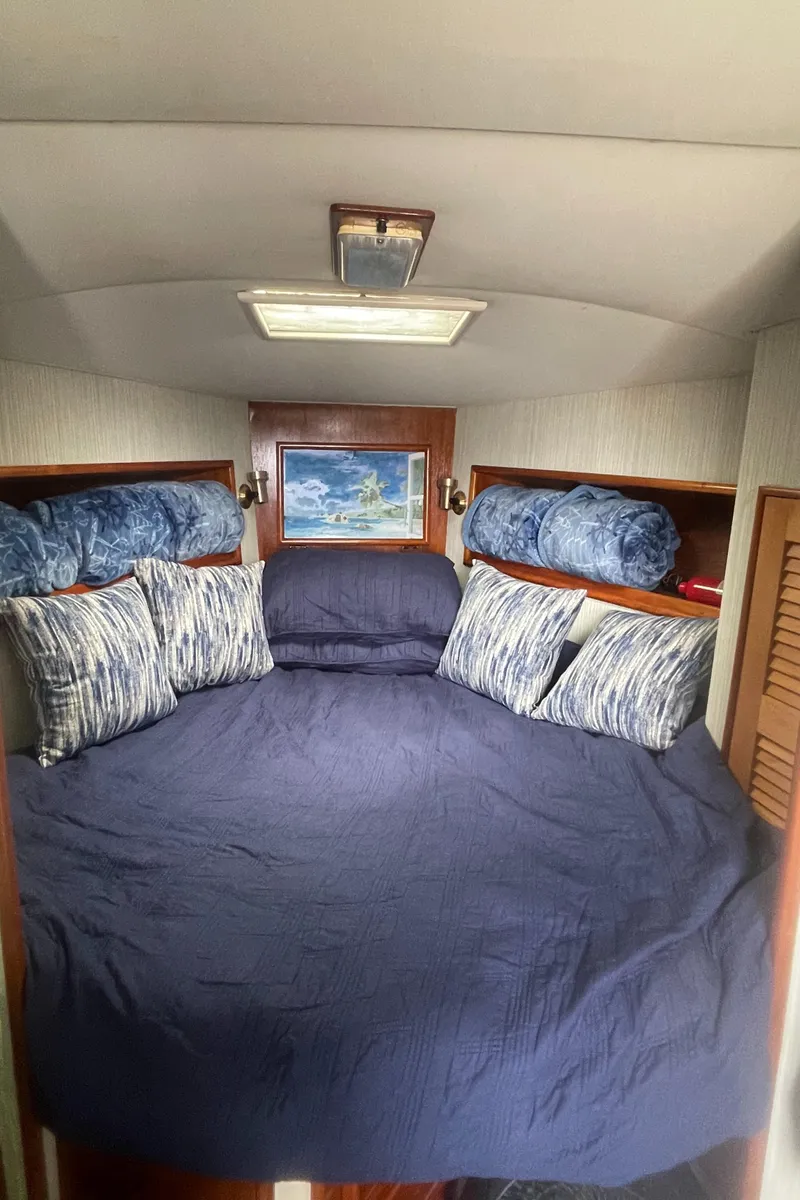 Slide: The Image of 1992 Ocean Yachts Sport Cruiser cabin with cozy bedding and nautical decor. - 18