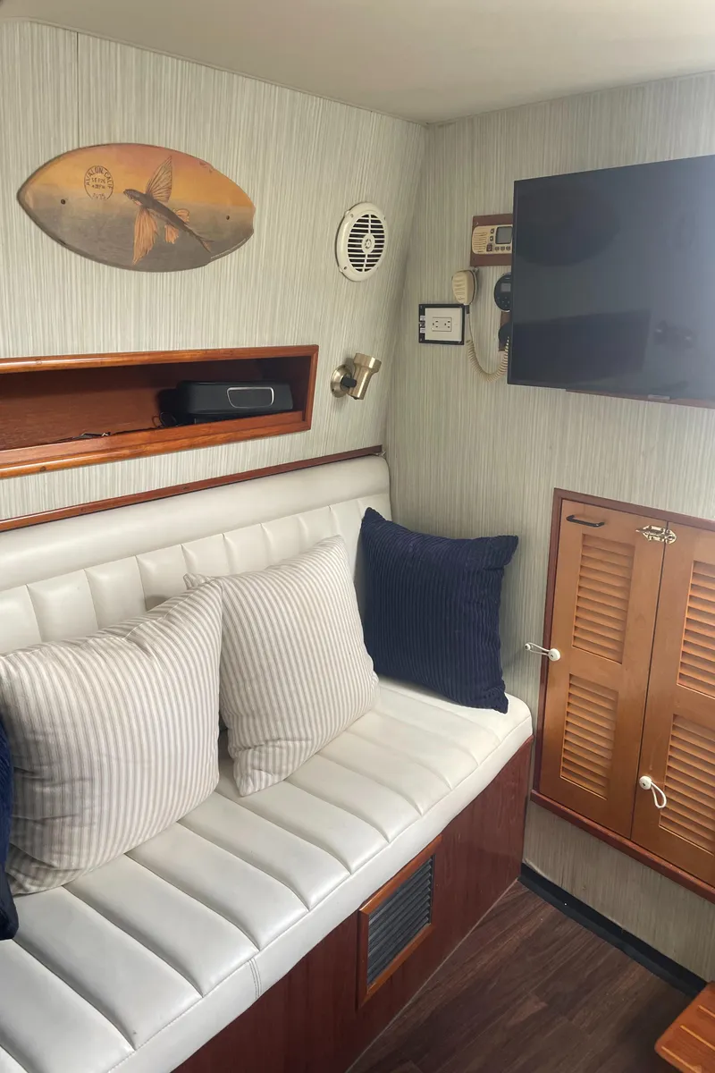 Slide: The Image of Interior of 1992 Ocean Yachts Sport Cruiser with white seating and nautical decor. - 21