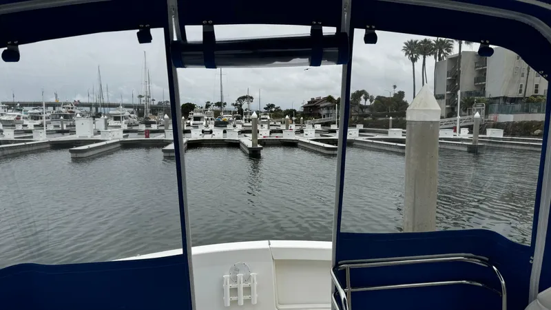 Slide: The Image of 1992 Ocean Yachts Sport Cruiser docked at a marina with overcast skies. - 5