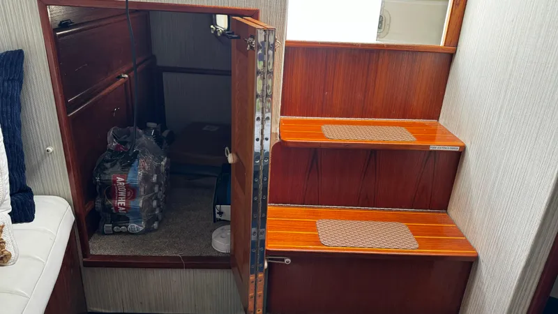 Slide: The Image of 1992 Ocean Yachts Sport Cruiser interior with wooden stairs and storage area. - 6