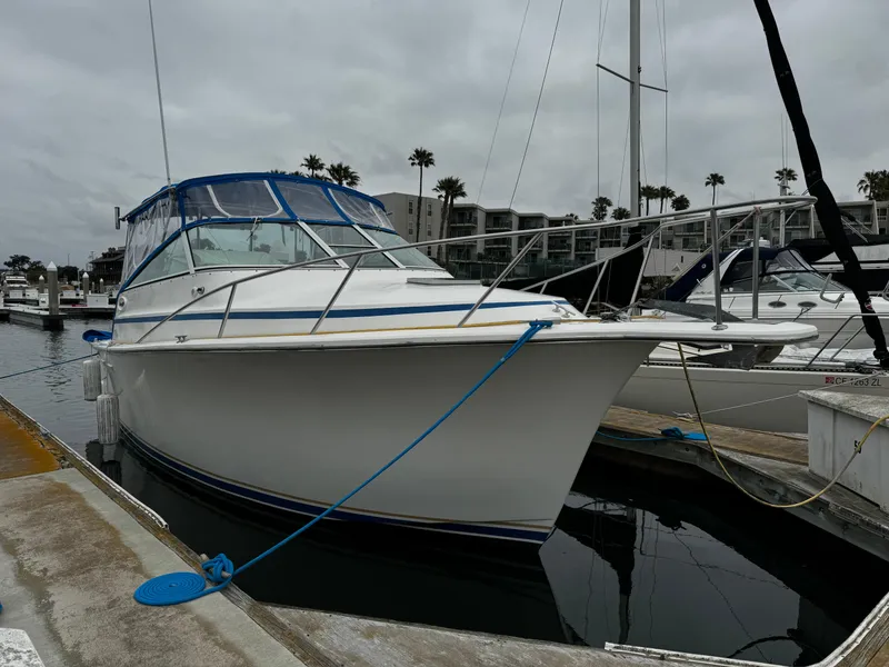 The Image of 1992 Ocean Yachts Sport Cruiser docked at marina under cloudy skies. - 1