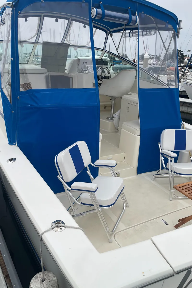Slide: The Image of 1992 Ocean Yachts Sport Cruiser with blue canopy and white seating. - 16