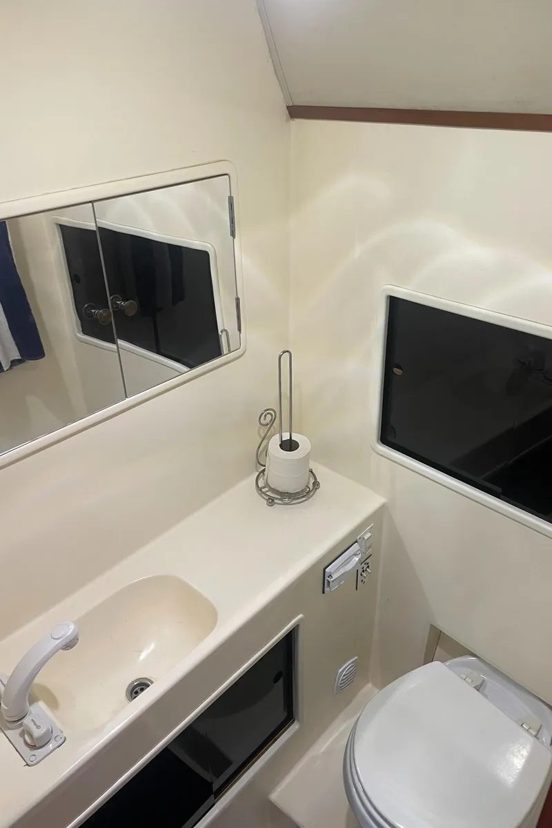 Slide: The Image of Bathroom interior of a 1992 Ocean Yachts Sport Cruiser with sink, mirror, and toilet. - 20