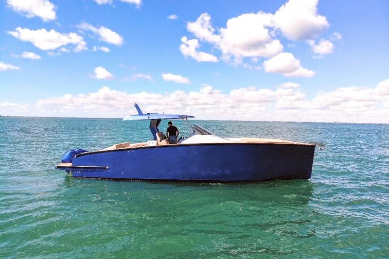 The Image of 2022 Tesoro T38 Outboard boat on calm sea under blue sky. - 0