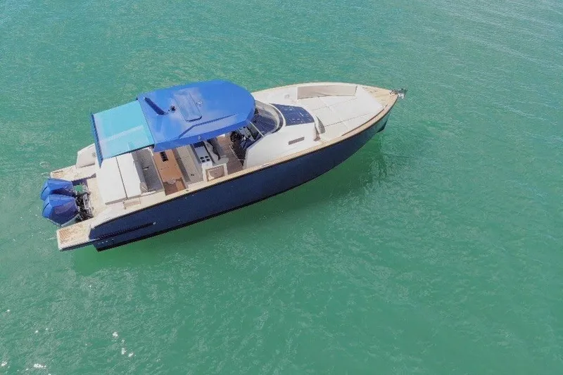 Slide: The Image of 2022 Tesoro T38 Outboard boat on clear turquoise water, aerial view. - 11