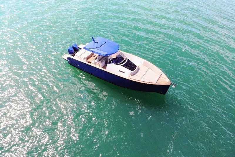 Slide: The Image of 2022 Tesoro T38 Outboard boat on clear turquoise water, aerial view. - 12
