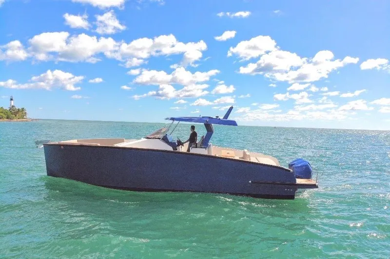 Slide: The Image of 2022 Tesoro T38 Outboard boat cruising on clear blue water under a sunny sky. - 13