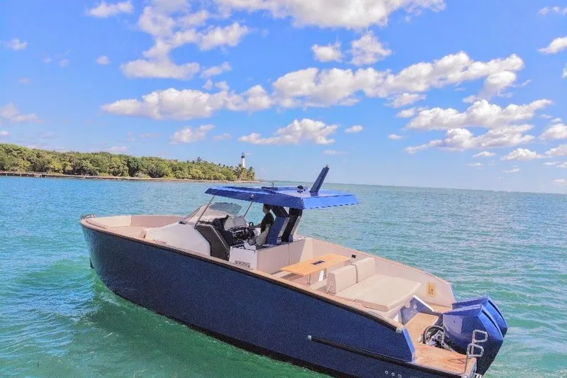 Slide: The Image of 2022 Tesoro T38 Outboard boat on clear blue water under a sunny sky. - 16