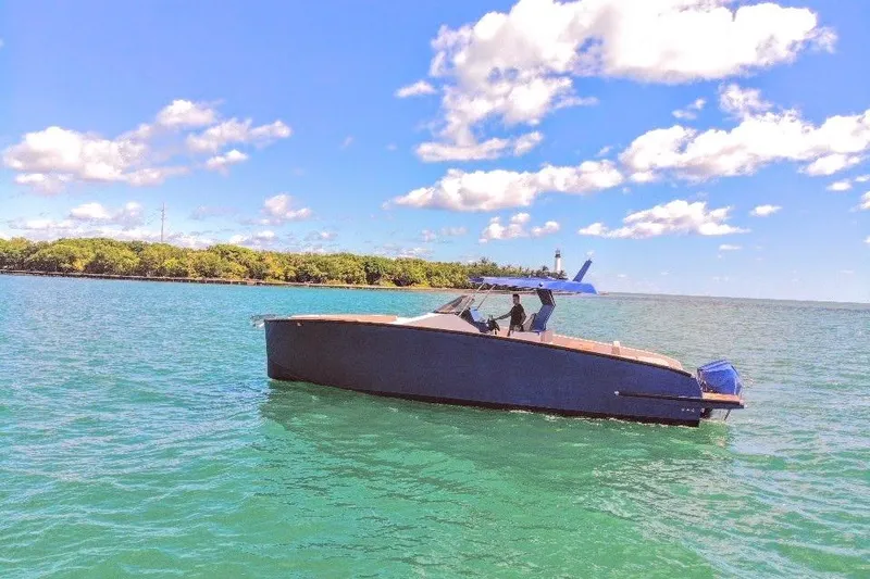 Slide: The Image of 2022 Tesoro T38 Outboard boat cruising on clear blue water under a sunny sky. - 17