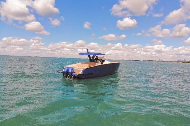 Slide: The Image of 2022 Tesoro T38 Outboard boat on open water under a partly cloudy sky. - 19
