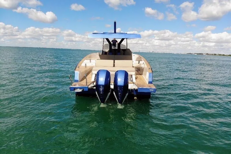 Slide: The Image of 2022 Tesoro T38 Outboard boat on open water under a partly cloudy sky. - 22