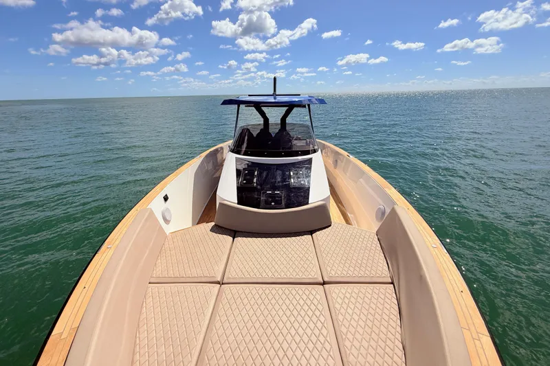 Slide: The Image of 2022 Tesoro T38 Outboard boat on open water under a clear blue sky. - 30