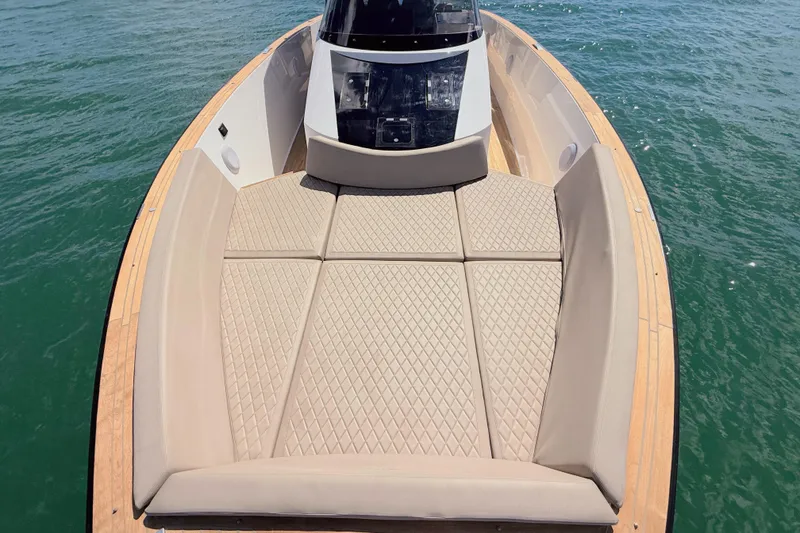 Slide: The Image of 2022 Tesoro T38 Outboard boat with spacious sunbathing area on calm water. - 31