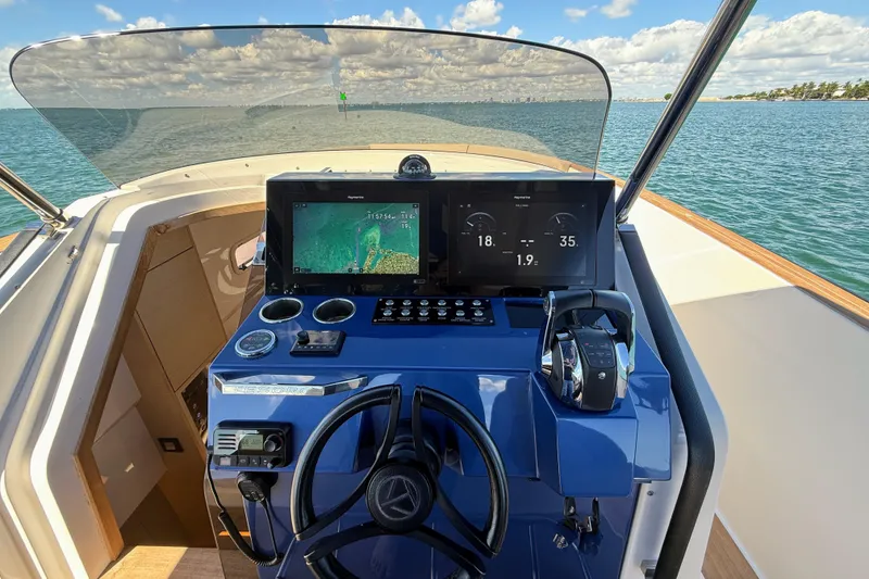 Slide: The Image of 2022 Tesoro T38 Outboard dashboard with navigation screens, steering wheel, and throttle controls. - 34
