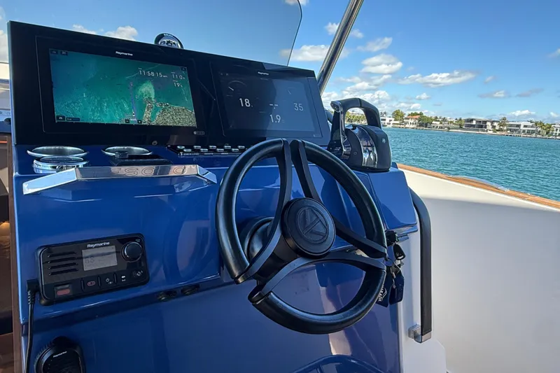 Slide: The Image of 2022 Tesoro T38 Outboard boat dashboard with navigation screens and steering wheel. - 35