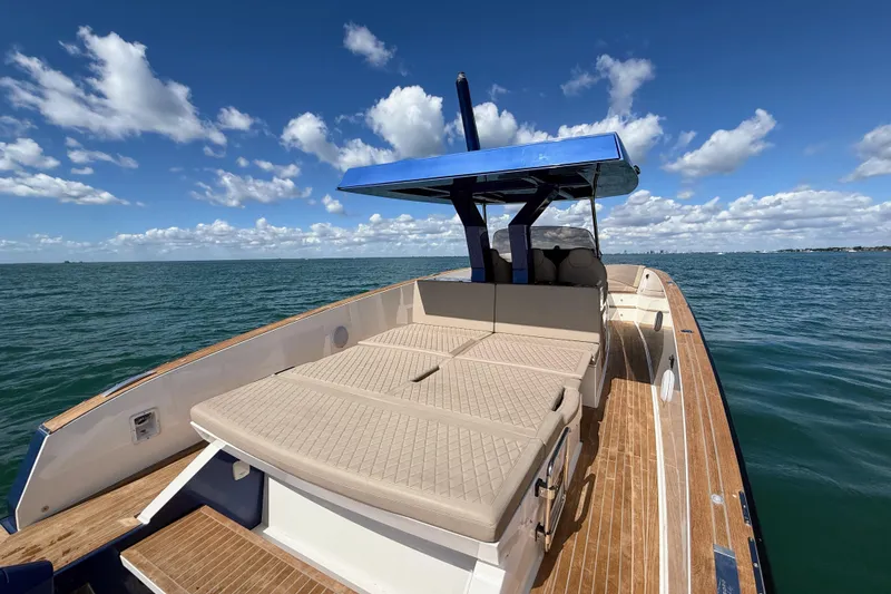 Slide: The Image of 2022 Tesoro T38 Outboard boat on open water under a clear blue sky. - 44