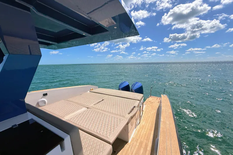 Slide: The Image of 2022 Tesoro T38 Outboard boat on open sea under blue sky and clouds. - 45