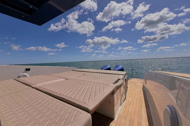 Slide: The Image of 2022 Tesoro T38 Outboard boat with sun deck, ocean view, and clear blue sky. - 46
