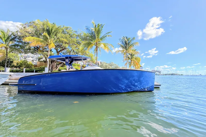 Slide: The Image of 2022 Tesoro T38 Outboard boat docked by palm trees on a sunny day. - 5