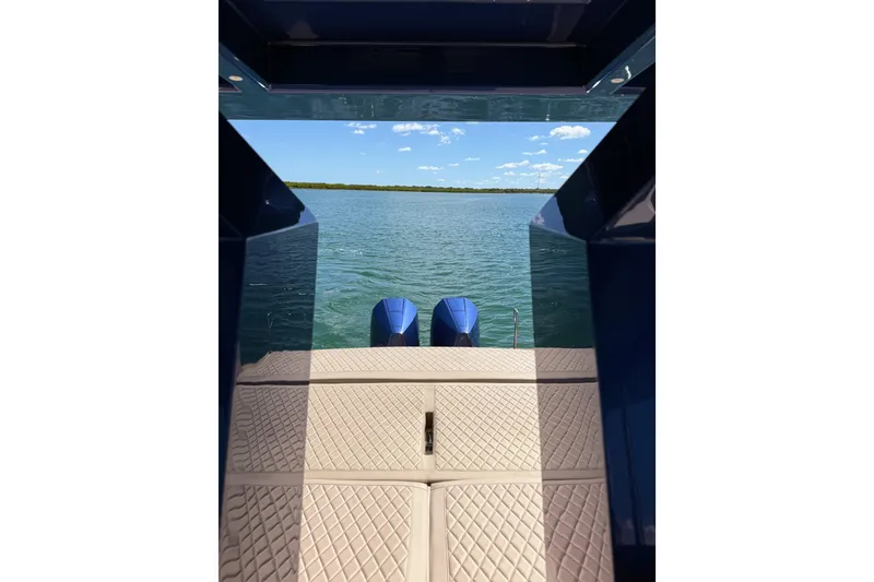 Slide: The Image of 2022 Tesoro T38 Outboard boat with dual engines on a calm lake. - 54