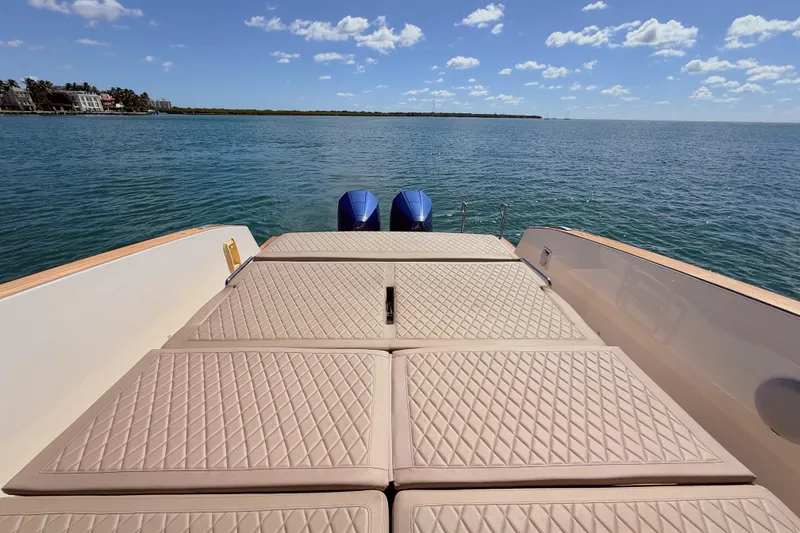 Slide: The Image of 2022 Tesoro T38 Outboard boat with cushioned deck, ocean view, and clear sky. - 55