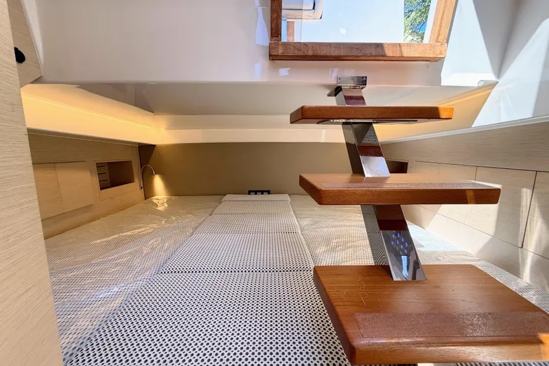 Slide: The Image of Interior of 2022 Tesoro T38 Outboard, featuring modern wooden steps and cozy cabin space. - 66