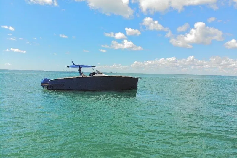 Slide: The Image of 2022 Tesoro T38 Outboard boat on calm sea under blue sky with clouds. - 8