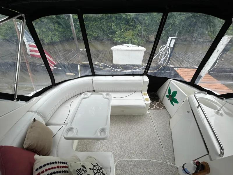 Slide: The Image of Interior of 2001 Cruisers Yachts 3470 Express with seating, table, and American flag view. - 10