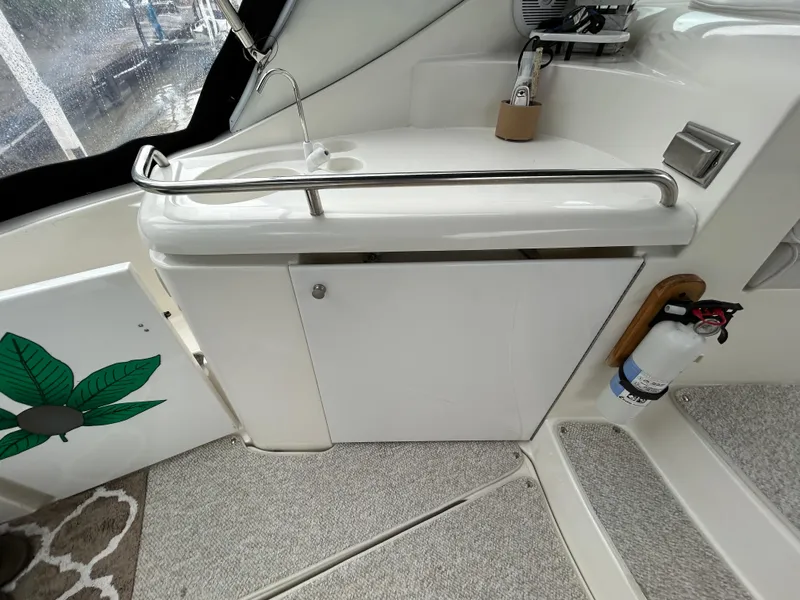 Slide: The Image of 2001 Cruisers Yachts 3470 Express interior with sink and fire extinguisher. - 13