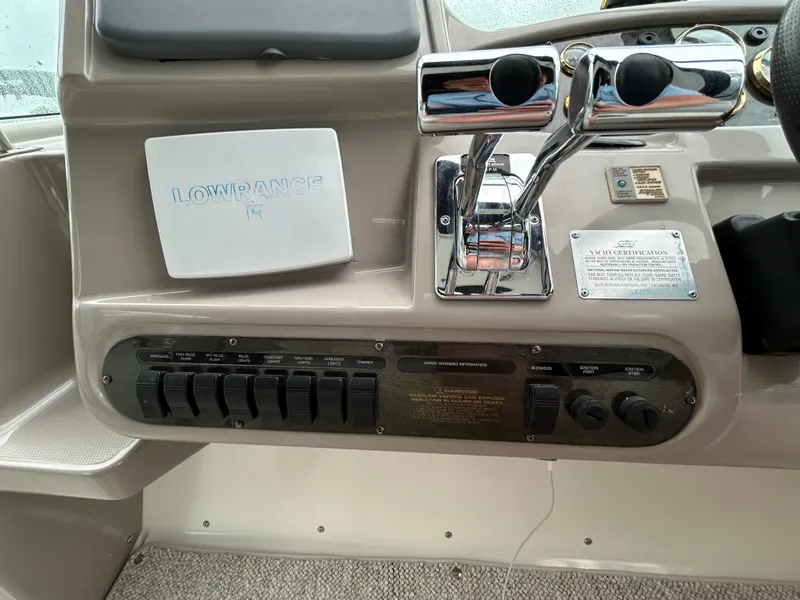 Slide: The Image of 2001 Cruisers Yachts 3470 Express dashboard with controls and Lowrance equipment. - 23