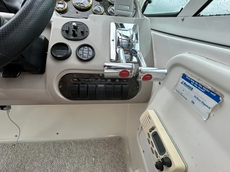 Slide: The Image of 2001 Cruisers Yachts 3470 Express helm with controls and gauges. - 24