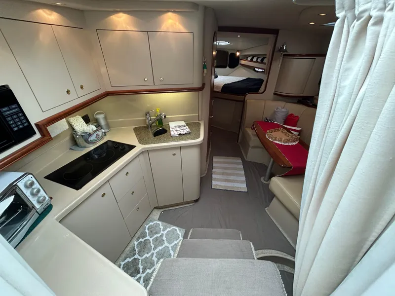 Slide: The Image of 2001 Cruisers Yachts 3470 Express interior with kitchen and dining area. - 28