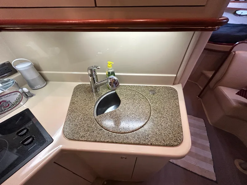 Slide: The Image of 2001 Cruisers Yachts 3470 Express kitchen sink with granite countertop and modern faucet. - 32