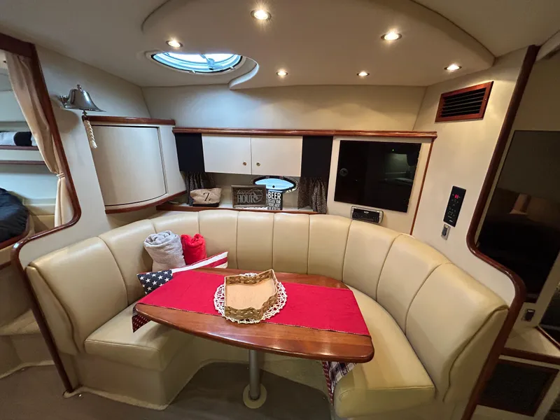 Slide: The Image of Luxurious 2001 Cruisers Yachts 3470 Express cabin with cozy seating and elegant decor. - 35