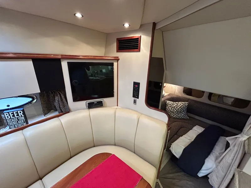 Slide: The Image of Interior of 2001 Cruisers Yachts 3470 Express with seating, TV, and cozy sleeping area. - 37