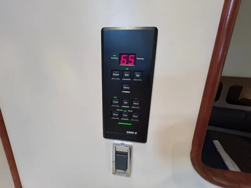 Slide: The Image of Digital thermostat on 2001 Cruisers Yachts 3470 Express, displaying 65 degrees. - 38