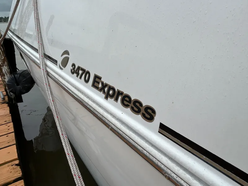 Slide: The Image of 2001 Cruisers Yachts 3470 Express docked, showing model name on hull. - 4