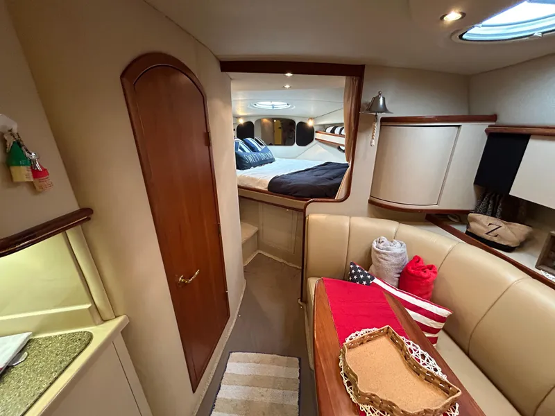 Slide: The Image of Interior of 2001 Cruisers Yachts 3470 Express, featuring cozy seating and a well-appointed cabin. - 40