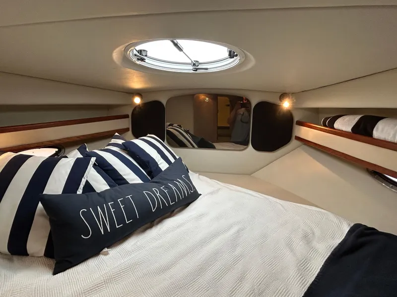 Slide: The Image of Cozy cabin interior of 2001 Cruisers Yachts 3470 Express with striped pillows and "Sweet Dreams" cushion. - 42