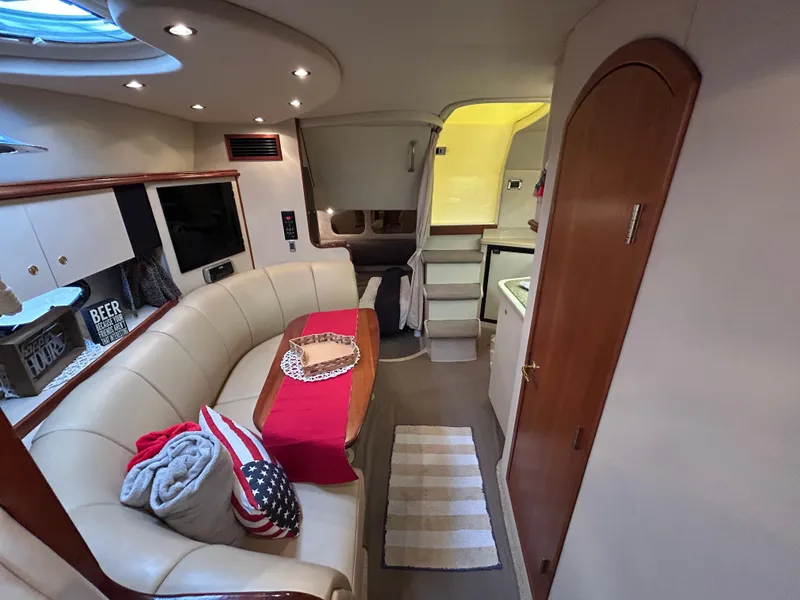 Slide: The Image of Interior of 2001 Cruisers Yachts 3470 Express, featuring cozy seating and modern amenities. - 45