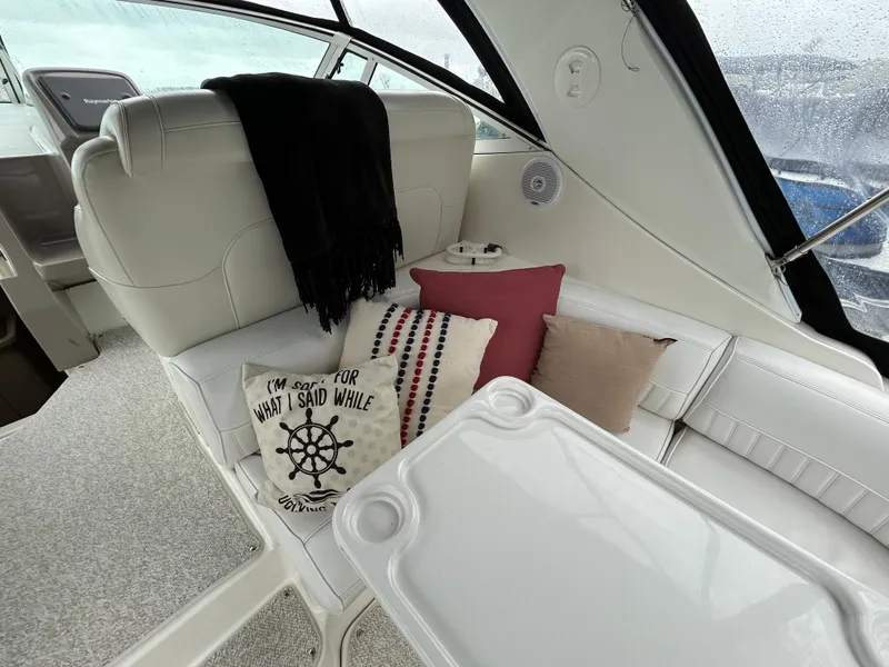 Slide: The Image of 2001 Cruisers Yachts 3470 Express interior with cozy seating and decorative pillows. - 9