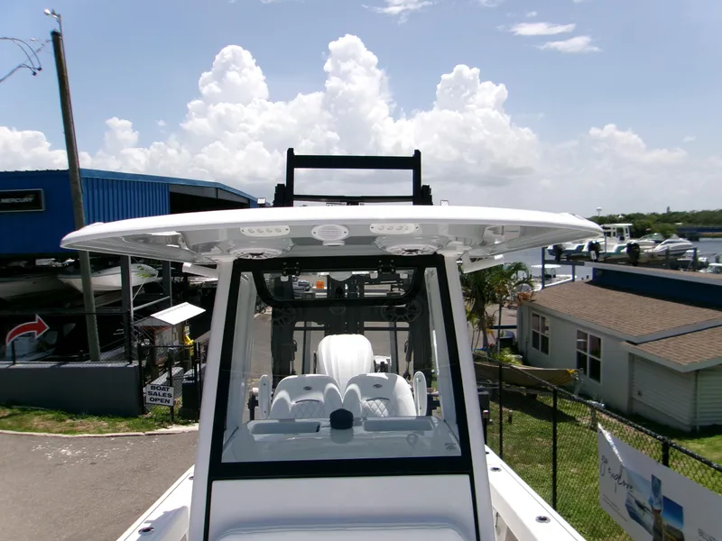 Slide: The Image of 2025 Sportsman Masters 247OE Bay Boat with T-top, docked under a cloudy sky. - 14